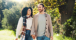 Outdoor, holding hands and couple on walk, nature and people with smile on date, romance and break. Park, man and woman in relationship, love and happy for interracial marriage, travel or together