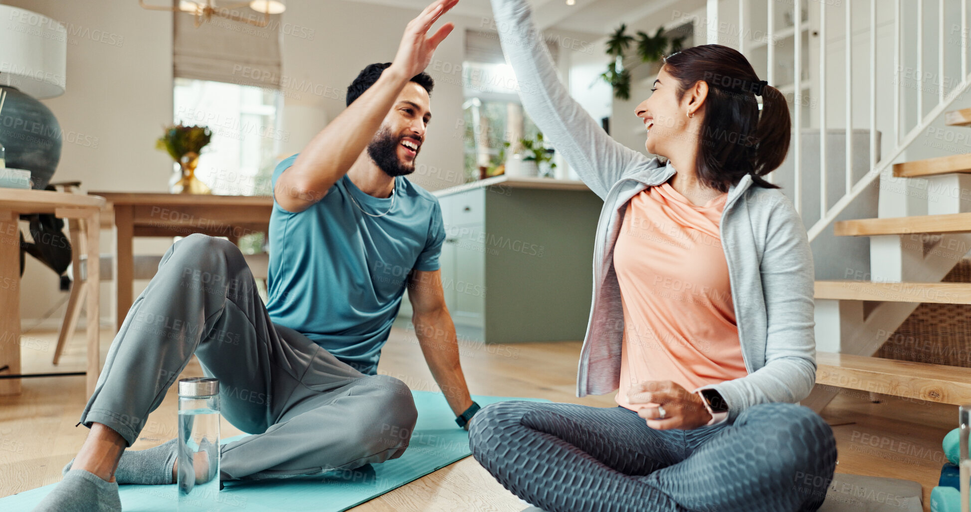 Buy stock photo Fitness, high five and smile with couple in living room of home for bonding, health or wellness together. Exercise, holistic or success with man and woman in apartment for yoga goals or milestone