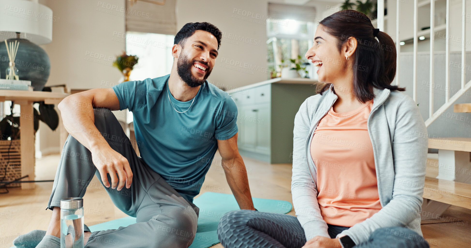 Buy stock photo Fitness, holistic and smile with couple in living room of home for bonding, health or wellness together. Exercise, love or yoga with funny man and woman laughing  in apartment for balance or relax