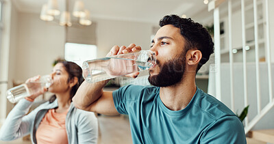 Buy stock photo Break, drinking water and fitness with couple in living room of home for bonding, health or wellness together. Exercise, hydration or thirsty with man and woman in apartment for balance or relax