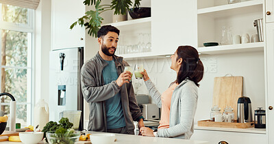 Buy stock photo Cheers, health and couple with smoothie in kitchen at home for wellness, diet and nutrition snack. Love, happy and man with woman for toast with green juice for vitamins or hydration in house.