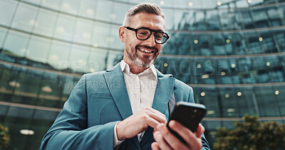 Buy stock photo Business, smile and man in city, smartphone and internet with social media, message to contact and texting. Mature person, outdoor and low angle in street, cellphone or digital app for communication