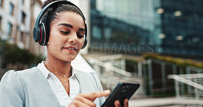 Buy stock photo Business woman, headphones and phone in city with commute, music and streaming sound on web. Person, smartphone and travel in town with audio, subscription and search for song on trip in Colombia
