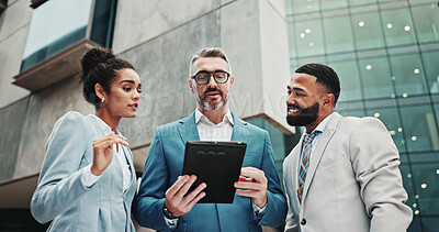 Buy stock photo Finance, colleagues and business people in city with tablet, news or review for feedback, project or sales. Account manager, teamwork or employees with tech for collaboration, low angle or discussion