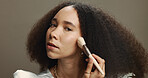 Woman, makeup brush and foundation in studio for beauty, portrait or application by background. Person, model and tools for color, gear or powder for cosmetic transformation with equipment in Brazil