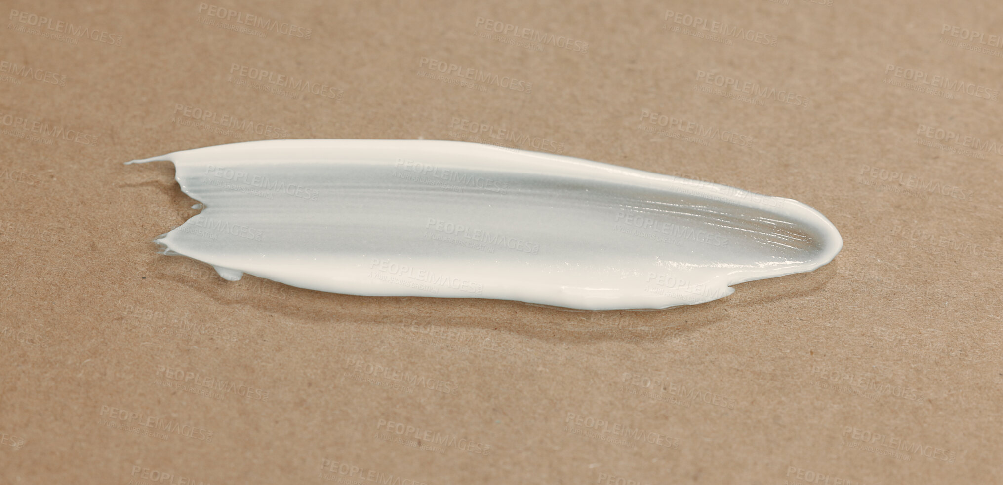 Buy stock photo Dermatology, beauty and smear of creme in studio for moisturizing, hydration or glow for treatment. Skincare, cosmetic and face routine with spf, lotion or sunscreen for wellness by brown background.