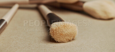 Buy stock photo Closeup, makeup brush and cosmetics with equipment in studio for transformation, beauty and color. Tools, gear and zoom for change, foundation or powder for skin, aesthetic and salon service on table