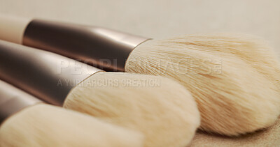 Buy stock photo Closeup, makeup brush and beauty with equipment in studio for transformation, cosmetics and color. Tools, gear and zoom for change, foundation or powder for skin, aesthetic and salon service on table