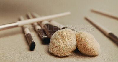 Buy stock photo Closeup, makeup brush and cosmetics with tools in studio for transformation, beauty and color. Equipment, gear and zoom for change, foundation or powder for skin, aesthetic and salon service on table