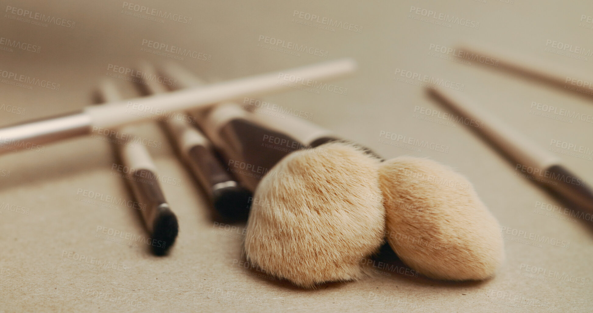 Buy stock photo Closeup, makeup brush and cosmetics with tools in studio for transformation, beauty and color. Equipment, gear and zoom for change, foundation or powder for skin, aesthetic and salon service on table