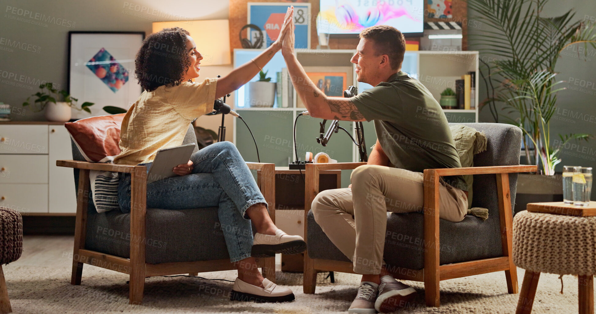 Buy stock photo Man, woman and happy for podcast, high five and home studio with cheers for live streaming on social media. People, excited and interview with achievement, celebration and goals for target audience
