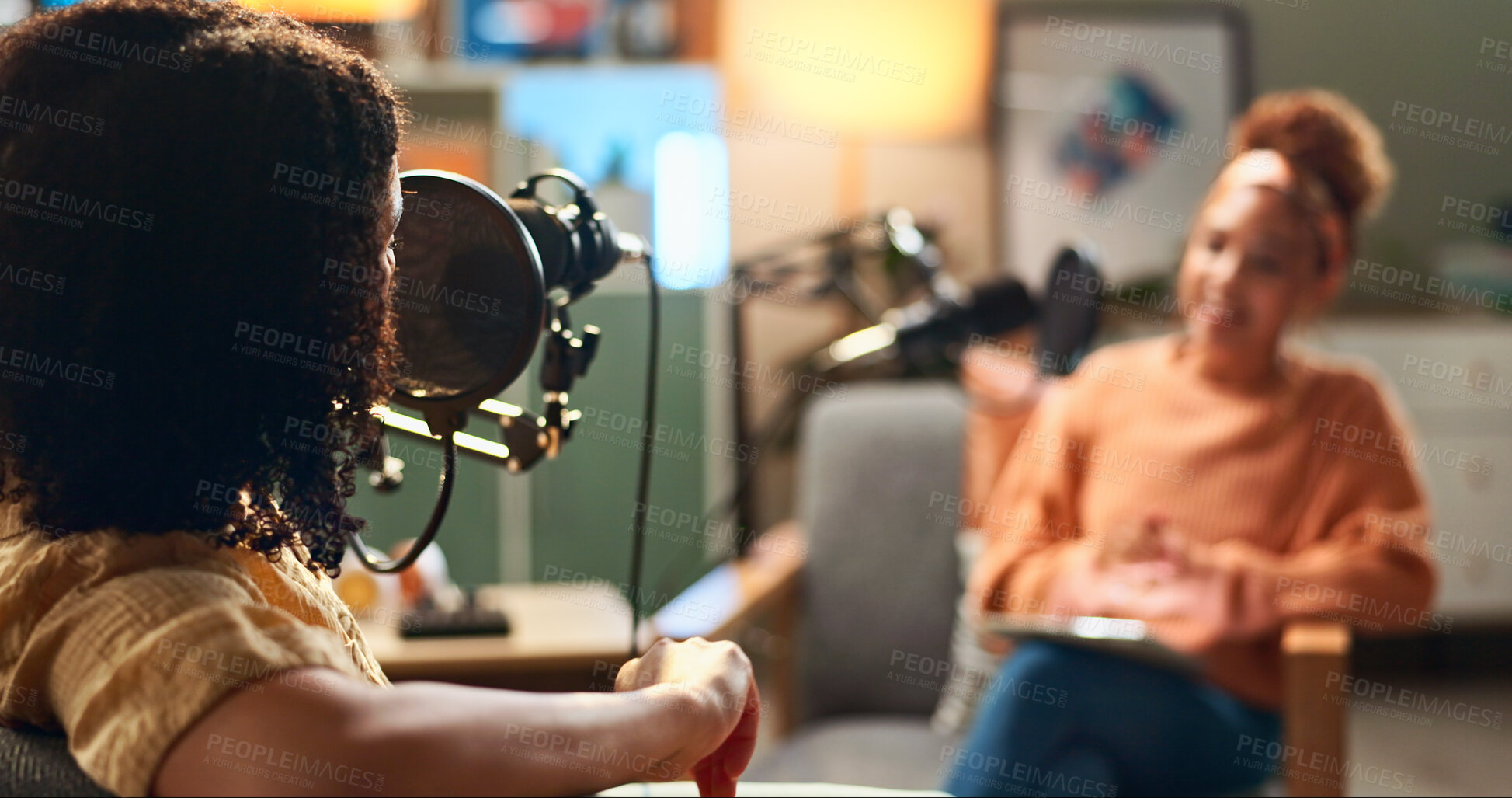 Buy stock photo Host, women and podcast interview with microphone for live conversation, talk show and current events. On air, radio presenter and guest in studio for social discussion, media streaming and broadcast