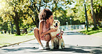 Woman, walk and dog in park, kiss and break for fitness with care, hug and outdoor in summer with loyalty. Person, animal or pet labrador on path for rest, bonding and training for wellness in Brazil