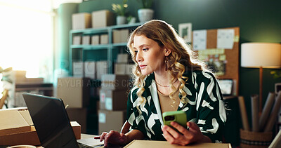 Buy stock photo Online shop, phone or woman with laptop at small business for inventory management or compare invoice. Ecommerce, startup owner or technology for logistics feedback, delivery tracking or multitasking