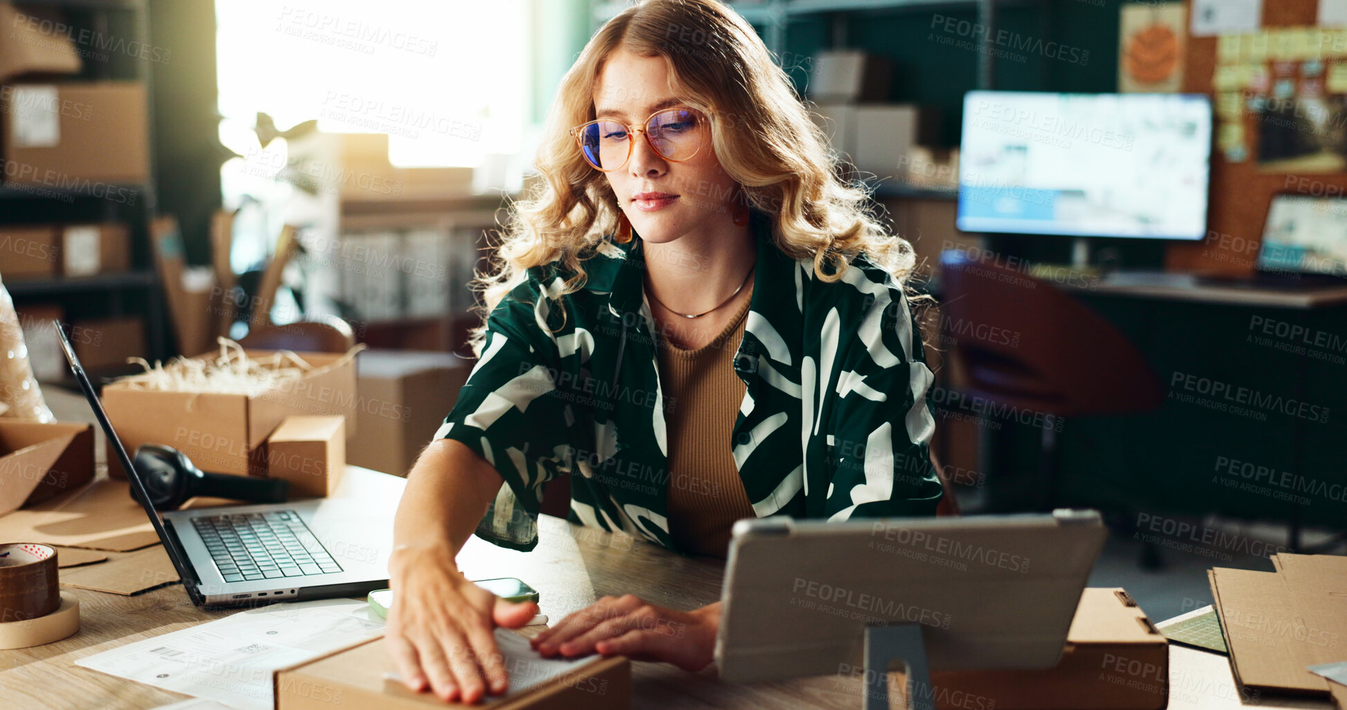 Buy stock photo Box, label and logistics with woman in office, tracking delivery or shipment of commercial goods. Laptop, supply chain and tablet with serious person in small business or warehouse for stock export