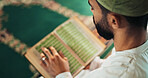 Muslim, man or Quran in mosque for learning, reading or mindfulness with worship to praise Allah. Islamic person, religion or above with holy book for guidance, studying scripture or prayer in temple