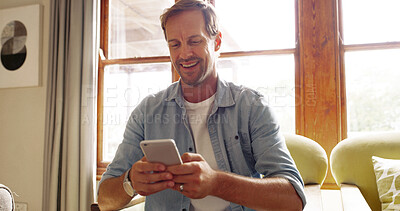Buy stock photo Home, typing and man with smartphone, smile and connection with message to contact. Apartment, mobile user and person in lounge, cellphone and digital app for social media, communication and chatting