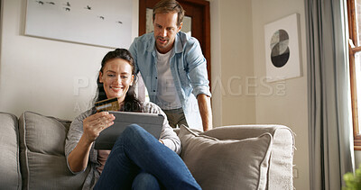 Buy stock photo Couple, online shopping and woman with card, tablet and browsing of digital products, lounge and website. House, customer and people with credit for purchase, man or partner with tech for transaction