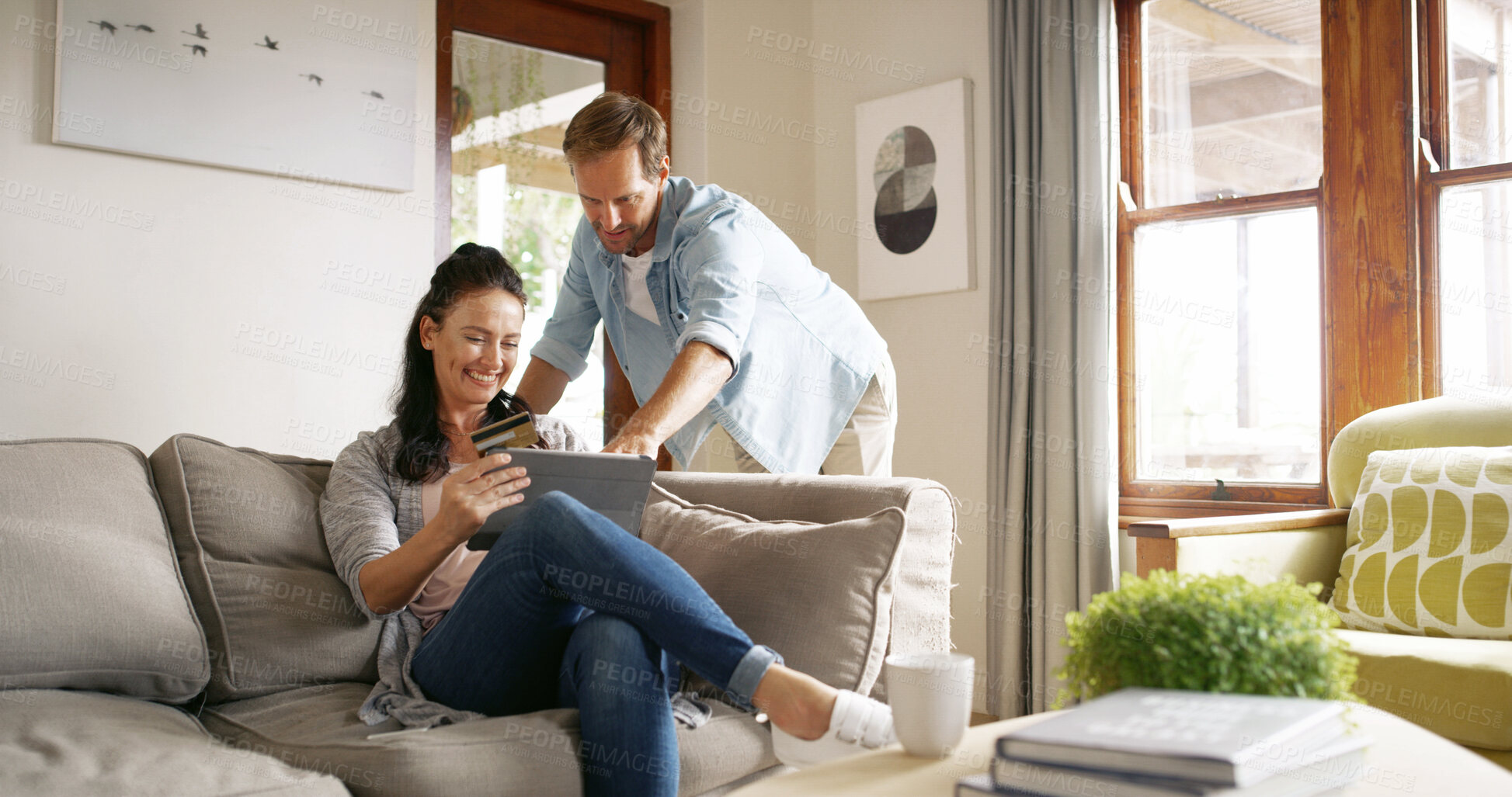 Buy stock photo Couple, woman and tablet with credit card in home for online shopping, digital purchase and mortgage payment. Happy, people and banking app on sofa for financial transaction, investment and ecommerce