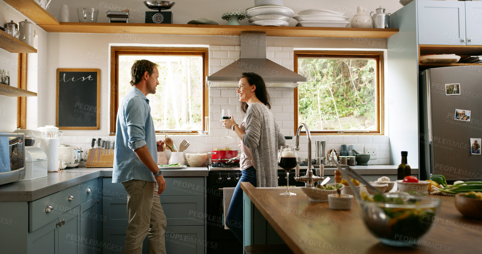 Buy stock photo Couple, wine and cooking food in kitchen with organic ingredients, meal prepare and anniversary. People, alcohol and nutrition salad for lunch date, bonding together and marriage celebration at house