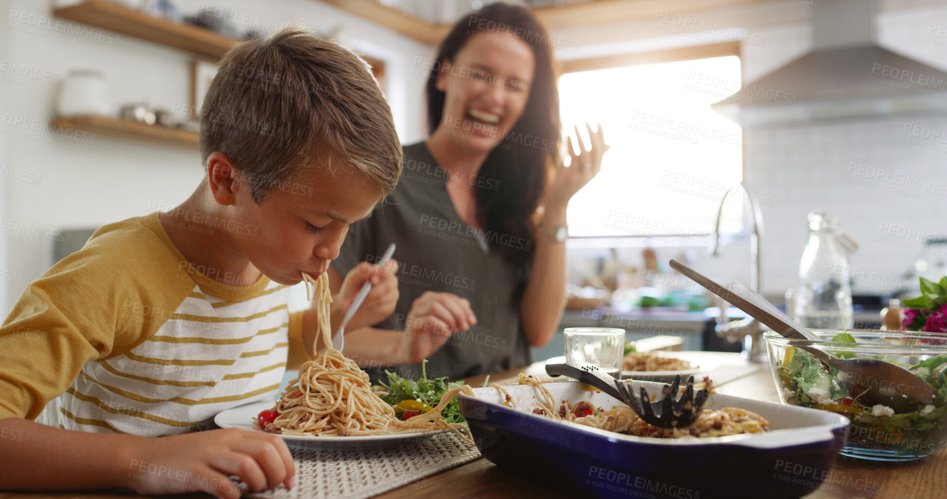 Buy stock photo Laugh, food and pasta with family at kitchen table for nutrition, bonding and healthy growth. Lunch, support and big appetite with mom and child eating at home for love, wellness and funny together