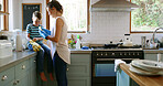 Home, cleaning and mother with boy, help or learning with chores, washing dishes or healthy hygiene. Parent, mama or son in kitchen, child development or conversation with housekeeping or remove dirt