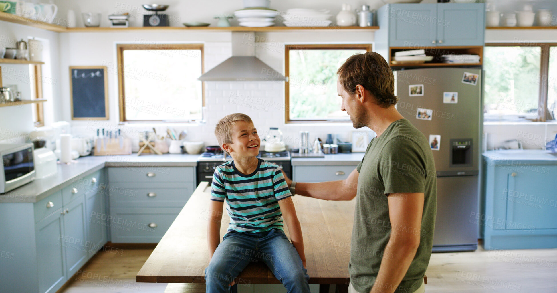 Buy stock photo Home, father and boy in kitchen, smile and funny with humor, support and bonding together. Parent, family and apartment with dad, son and happiness with break, conversation and laughing for joke