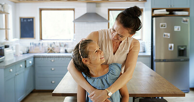 Buy stock photo Mother, laughing and hug kid in kitchen for funny joke, playful family and bonding together. Smile, woman and embrace with girl for love, affection and support with care for weekend break at house