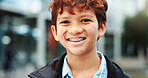 Outdoor, school and boy with happiness in portrait, education and studying opportunity with smile. Campus, male child and student with with confidence for elementary, learning academy and learner