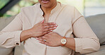 Senior person, hands and chest pain with heart attack on sofa for health fail, artery pressure and medical emergency. Cardiovascular, closeup or discomfort with cardiac arrest or hypertension in home