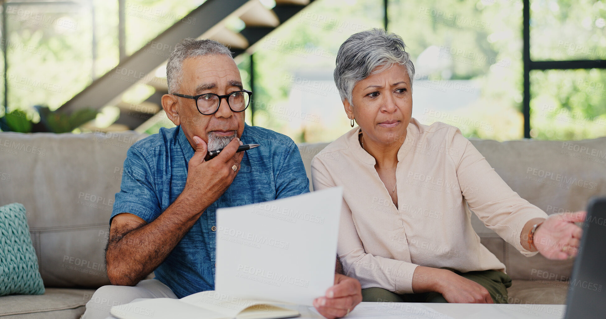 Buy stock photo Stress, paperwork and senior couple on sofa in discussion for debt, mortgage or bills repayment. Argument, upset and elderly man with woman for conversation on retirement funds with documents in home
