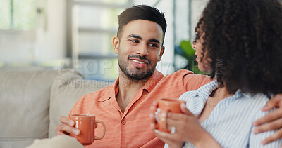 Buy stock photo Happy, talking and couple with coffee in home for chat, conversation and discussion together on weekend. Apartment, house and woman with man embrace with warm drink for relationship, bonding and love
