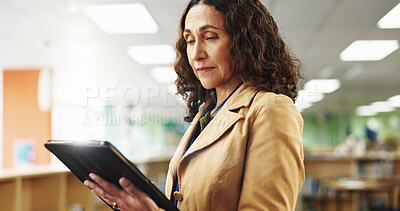 Buy stock photo Professor, college and woman in library with tablet, education and research for knowledge. University, teacher and mature person with online app, news or technology for curriculum, school or syllabus