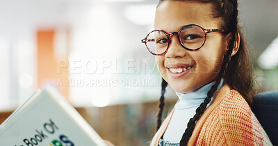 Buy stock photo Girl, kid and portrait with reading book at library for education, learning or glasses for storytelling. School child, happy and scholarship for language, knowledge and development in Costa Rica