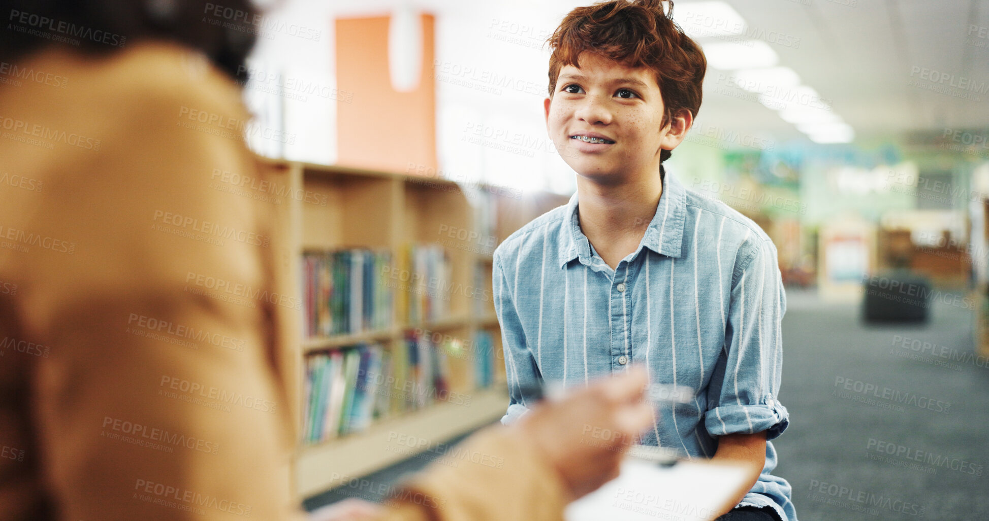 Buy stock photo Talking, library and child with school counsellor for future, development or career assessment. Discussion, education and therapist with boy student for behavior analysis at campus for growth.
