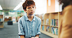Children, counseling or listening with boy and therapist in library of school for assessment or review. Education, occupational therapy and support with student speaking to counselor for feedback