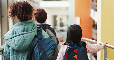 Buy stock photo Back, walking and students at school for education, knowledge or future with development. Bag, learning and group of children on campus in morning for scholarship, studying or academy together.