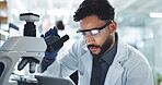 Man, scientist and tablet with microscope in lab for research, investigation and medical discovery. Person, biotechnology and information of pharmaceutical experiment, healthcare solution and vaccine