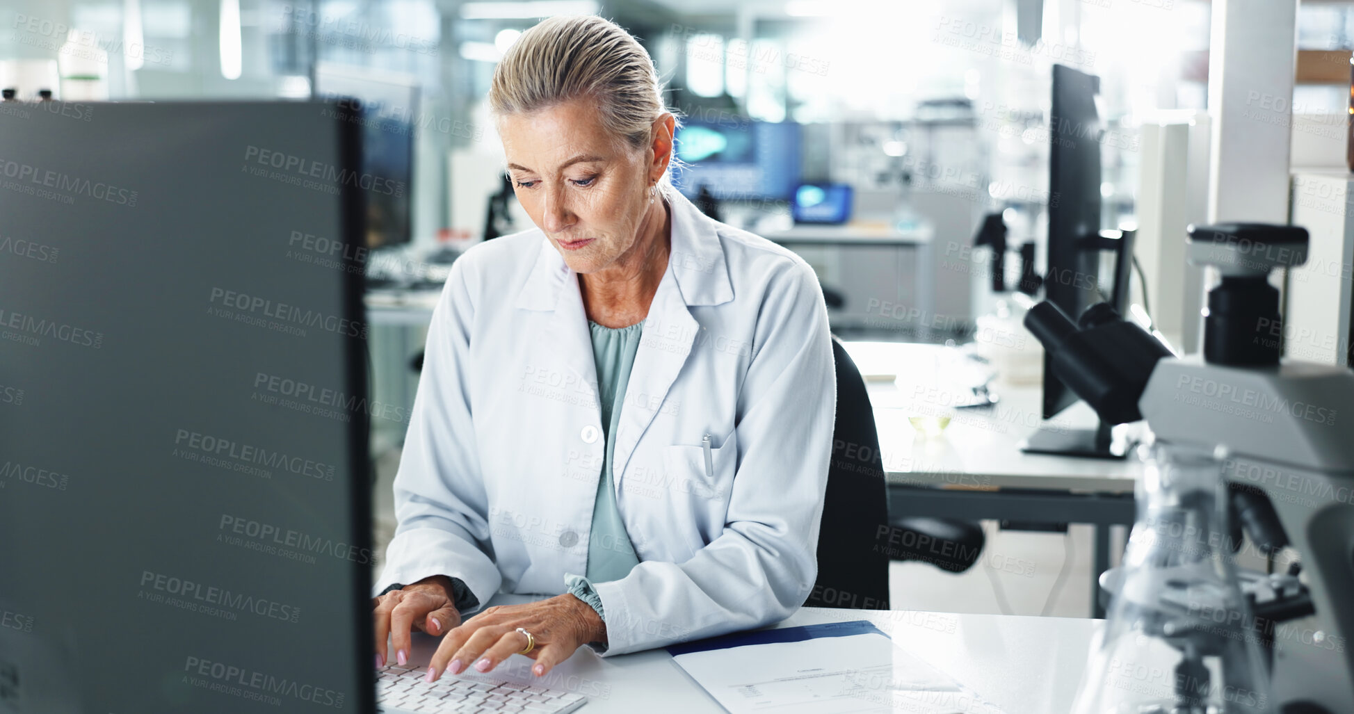 Buy stock photo Woman, scientist and typing with research on computer for medical results or discovery at laboratory. Mature, female person or health science worker with technology for scientific report or analysis