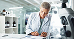 Woman, scientist and writing with documents for medical results or discovery at laboratory. Female person, science or healthcare worker with paperwork for scientific report, clinic trial or analysis