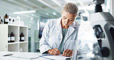 Buy stock photo Woman, scientist and writing with documents for medical results or discovery at laboratory. Mature person, science or healthcare worker with paperwork for scientific research, report or analysis