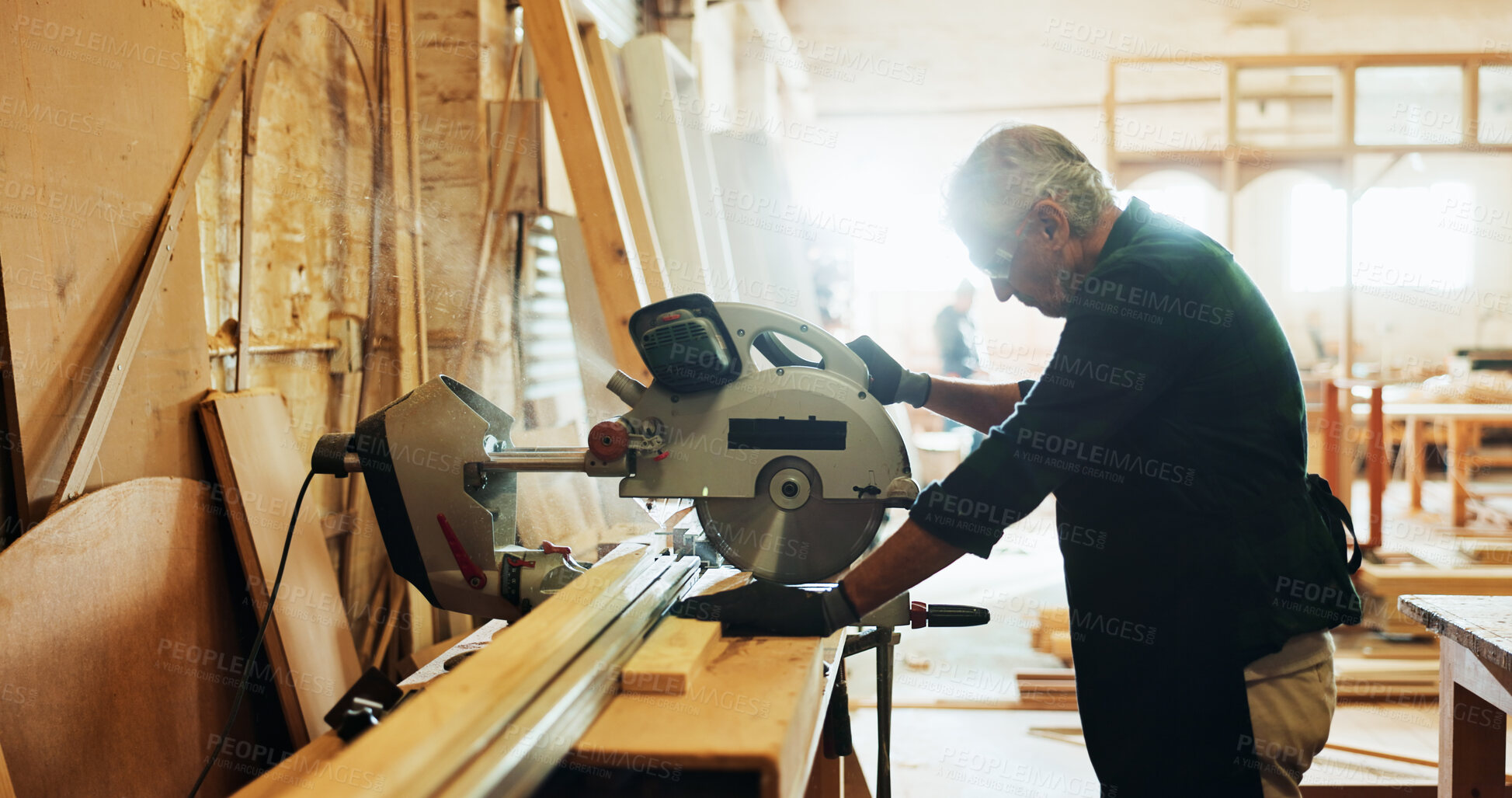 Buy stock photo Factory, man and machine with wood for carpenter, diy manufacturing and production business. Workshop, mature person and contractor with saw tools for furniture service, maintenance and cutting plank