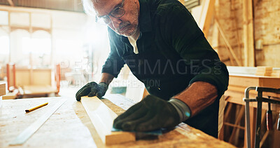 Buy stock photo Carpenter, woodworking and man with sandpaper, skills and smooth surface with tool or manufacturing. Production, artisan and mature person with gloves for safety and polishing of material in business