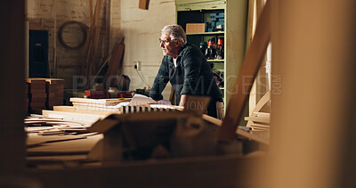 Buy stock photo Carpenter, thinking and man in shop, manufacturing and ideas for woodworking in business and table. Construction, entrepreneur and mature person with material for furniture, contemplating and serious