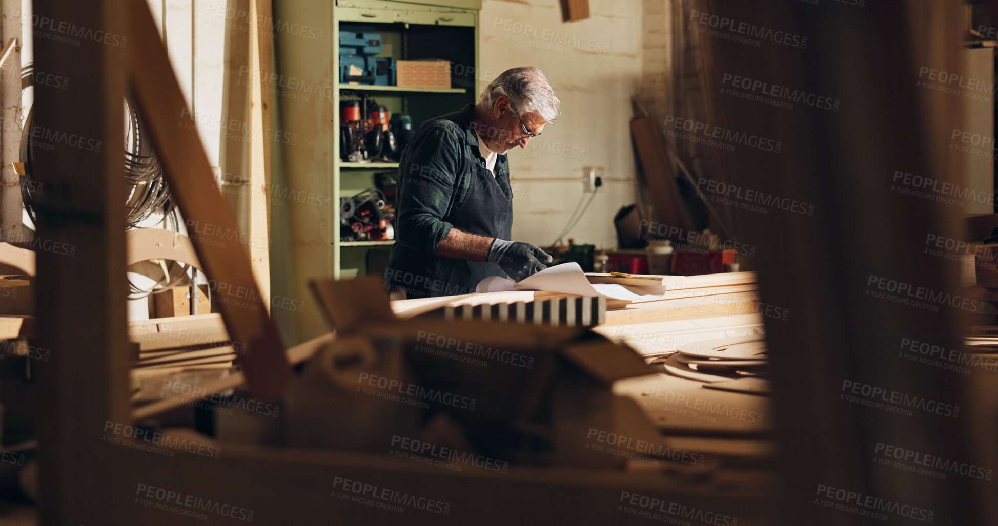 Buy stock photo Carpenter, thinking and man with blueprint, woodworking and ideas for manufacturing, table and business. Construction, entrepreneur and mature person with material for furniture and floor plan