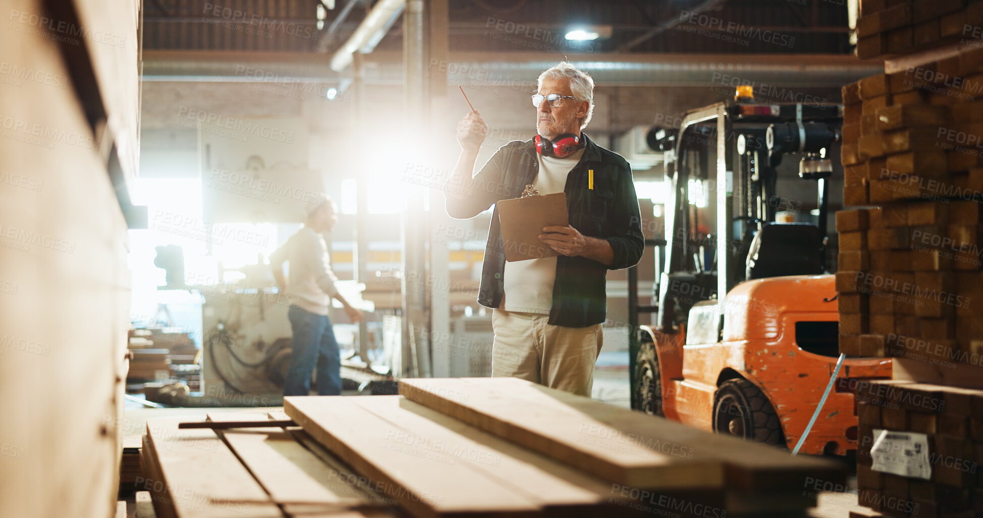 Buy stock photo Carpenter, man and clipboard with wood inspection for quality control, stock management or timber count. Manufacturing, mature person and paperwork for carpentry inventory or supply chain in workshop