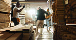 Carpenter, wood and dance with people in warehouse for furniture production, celebration and industry. Success, achievement and teamwork with employees in factory for lumber, excited and craftsman