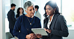 Tablet, business women and conversation in office, planning or mentor help intern with financial project. Team manager, technology and discussion for training, advice and budget solution in meeting