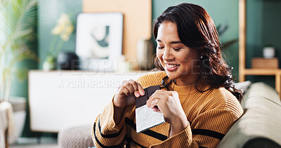 Buy stock photo Happy, chocolate and woman with snack, home and relax in living room with tasty treat or junk food. Break, smile and enjoying candy in lounge, sugar or nutrition in dessert, eating or person in house