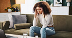 Frustrated woman, headache and stress with water on sofa for medication, diagnosis or symptoms at home. Sick, female person or illness with depression or pills on couch for side effects at house